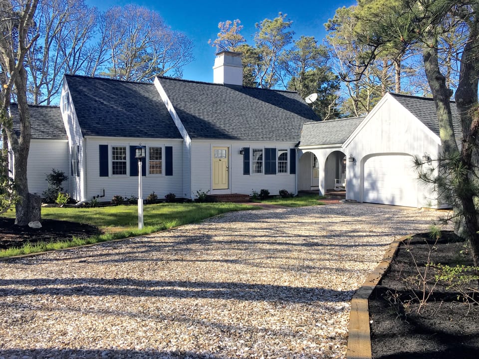 View of front of house with crushed shell driveway.