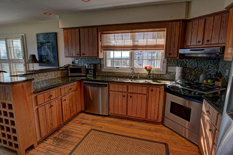 Granite countertops, stainless steel appliances and tile backsplash