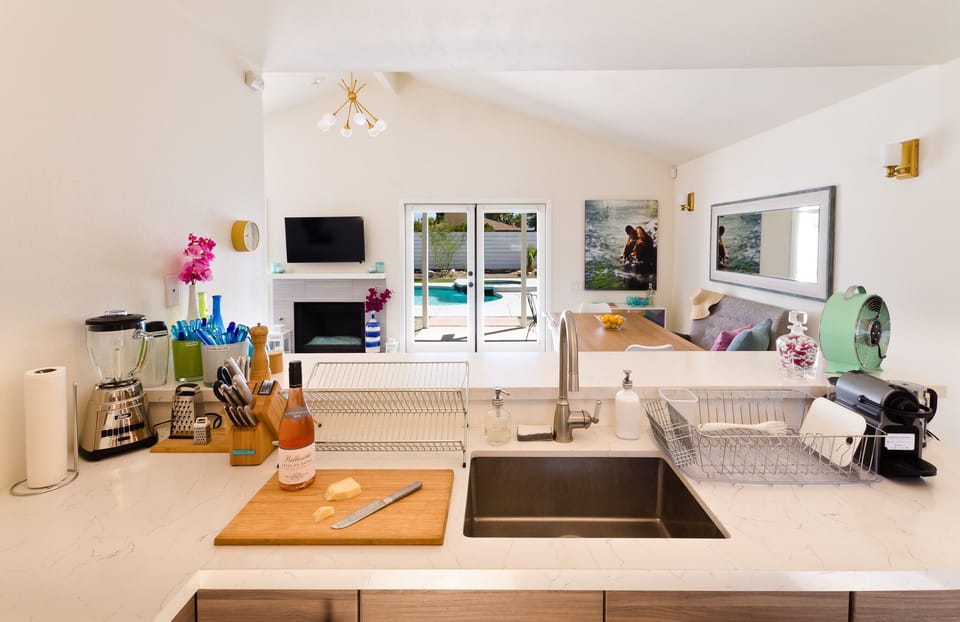 Kitchen looks over to the living area and pool