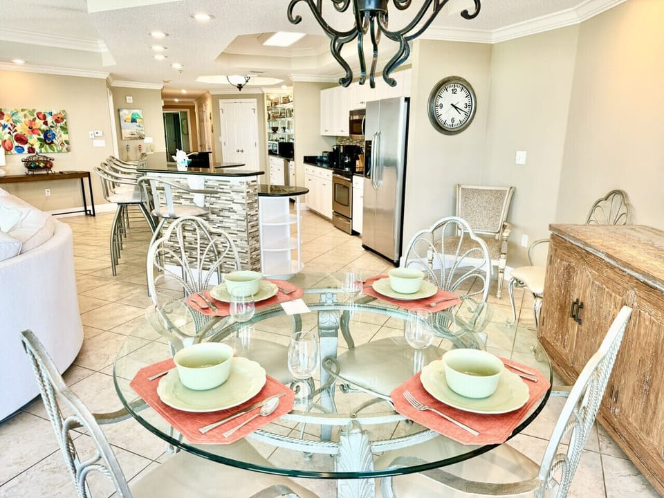 Dining table located right near kitchen without obstruction.