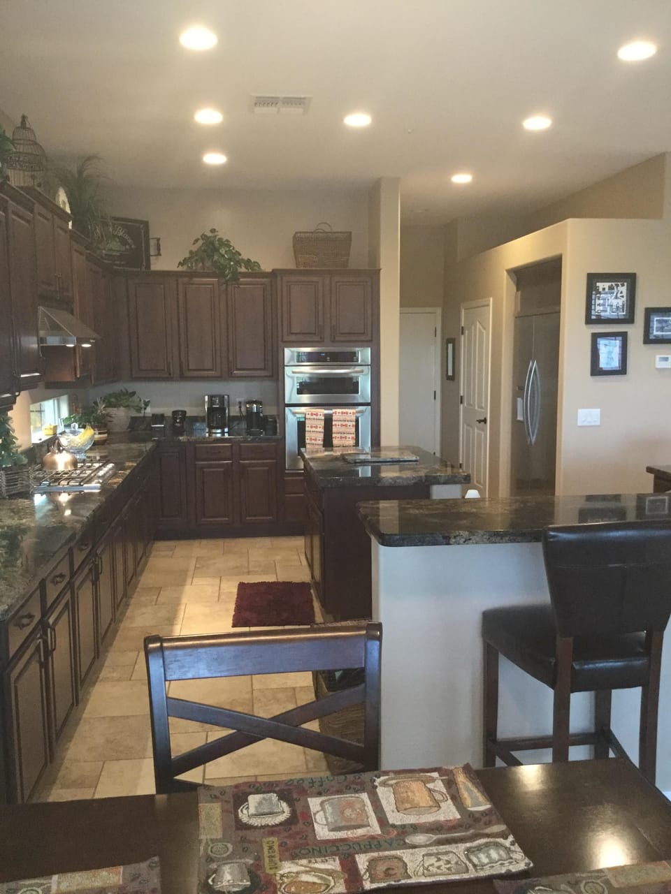 Gourmet kitchen and eating bar. Gas cooktop with 46 inch fridge