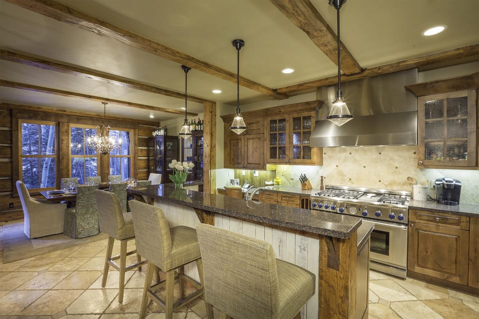 Well-stocked kitchen has high end appliances.