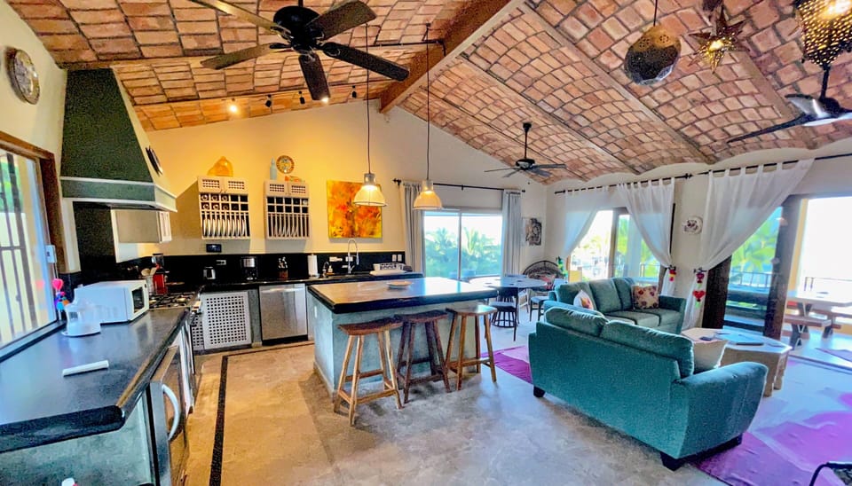 kitchen and living room area leading to upper terrace