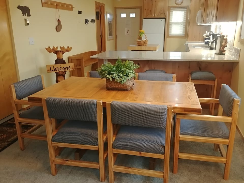 Dining room and kitchen with bar seating. View of Main Street and mountains.