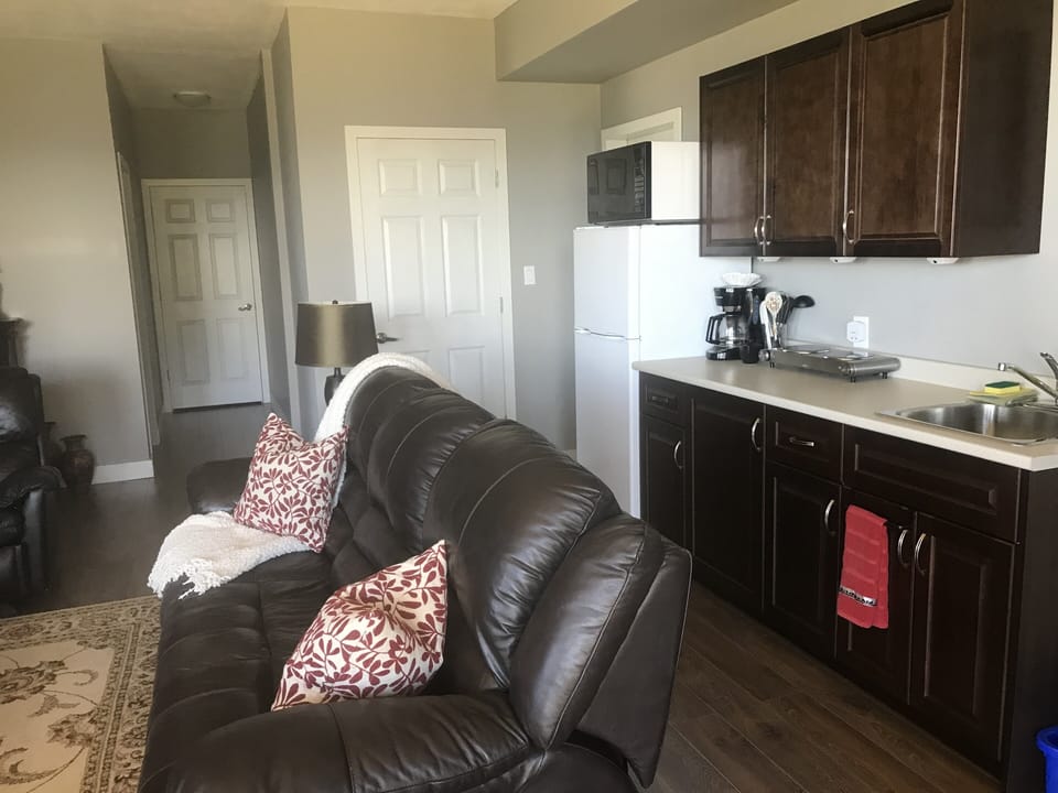 Kitchen has apartment size fridge, microwave, double hot plate and toaster oven