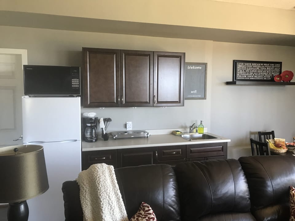 Fully equipped kitchen with hot plate, microwave, coffee maker, and toaster