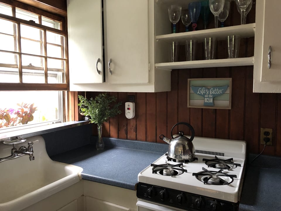 Smaller cottage has stove/oven, refrigerator, coffee maker, toaster and micro.