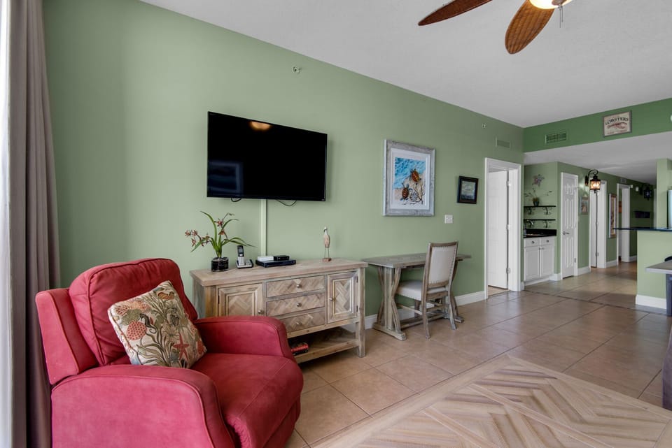 Living Room - Step into coastal living with this airy beachfront living room, boasting cozy seating, a large flat-screen TV, and endless ocean views for total comfort.