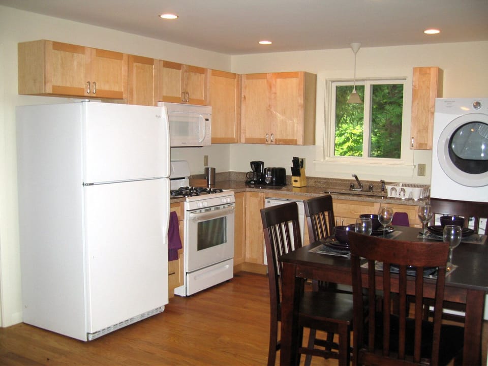 Kitchen with dishwasher. In unit washer and dryer. 