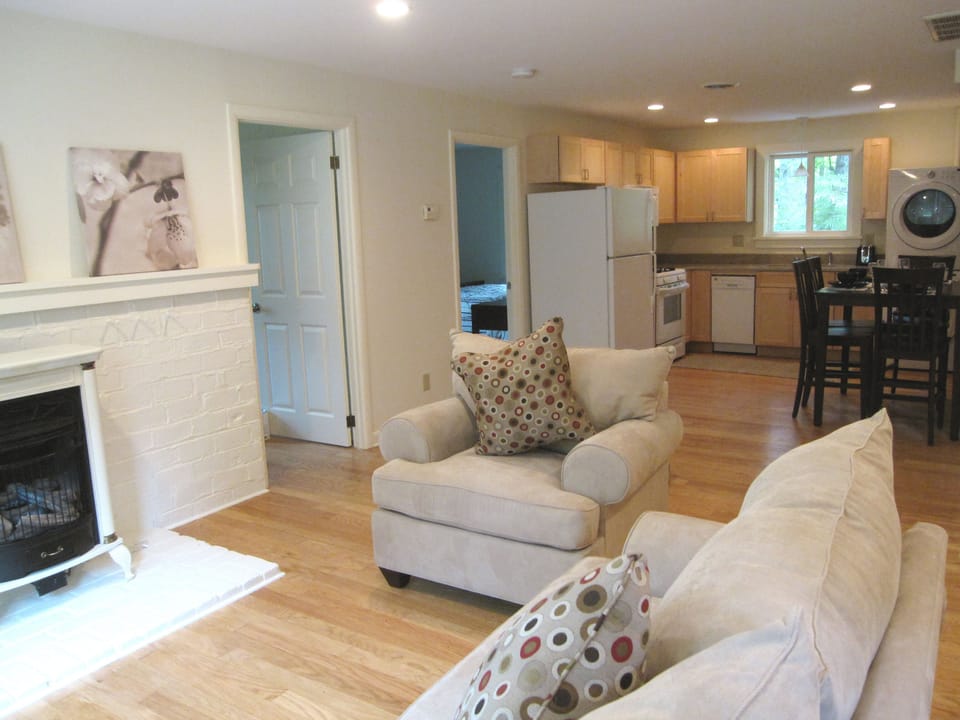 Open concept floor plan. Living room with fireplace that leads into the kitchen.