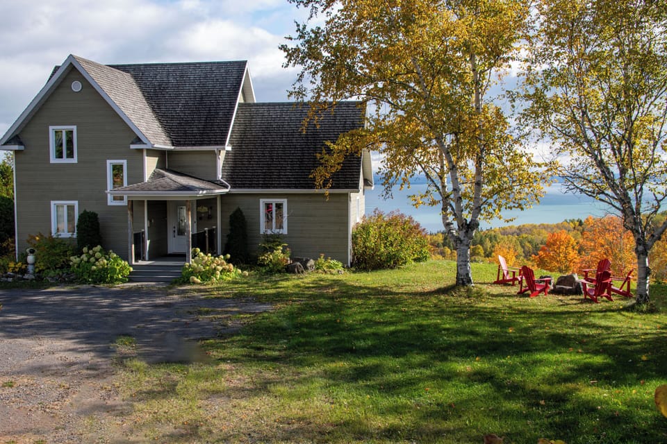 an exterior fire place nearby with a view on the river

