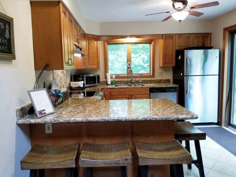 Fully equipped kitchen with granite countertops and stainless steel appliances 