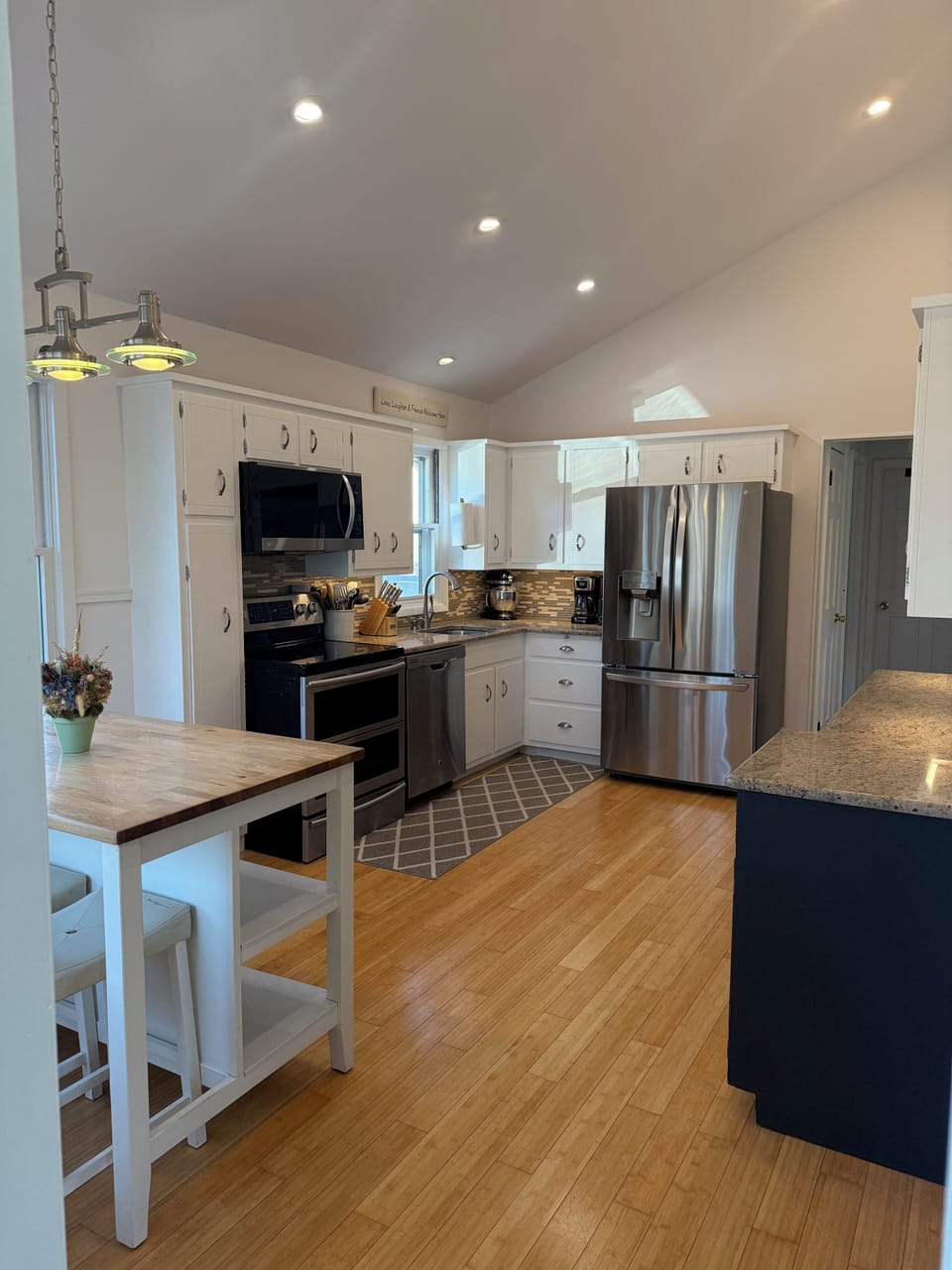 Large vaulted ceiling kitchen with granite and stainless steel appliances