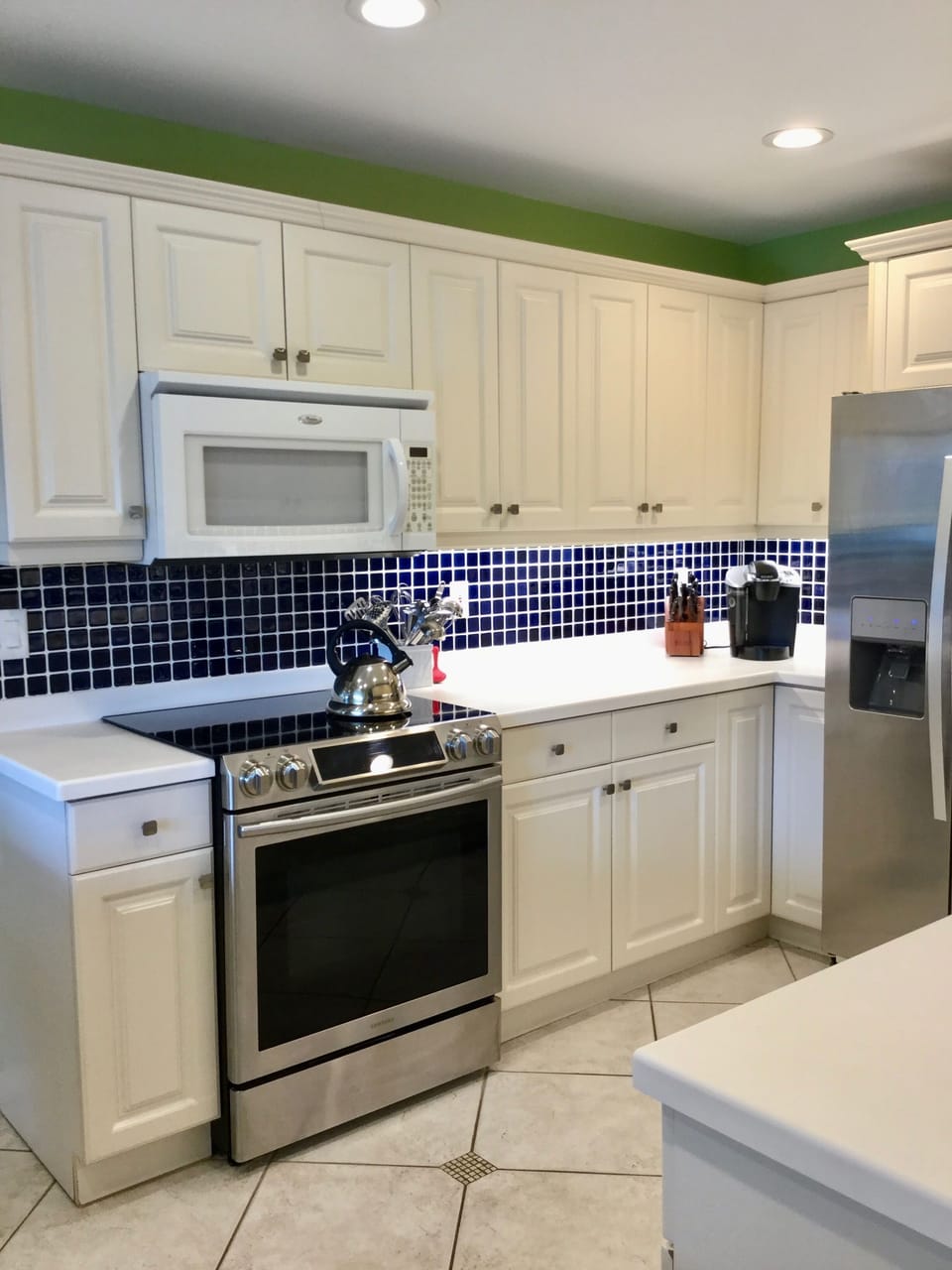 Kitchen with Stainless Steel Oven Range and fridge.