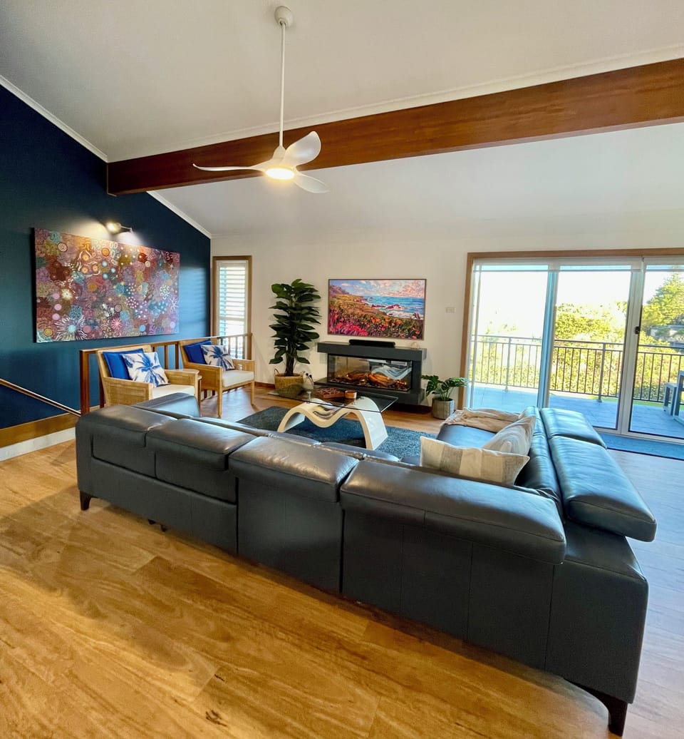 Large casual living area with Smart Samsung TV, fireplace and reclining lounge