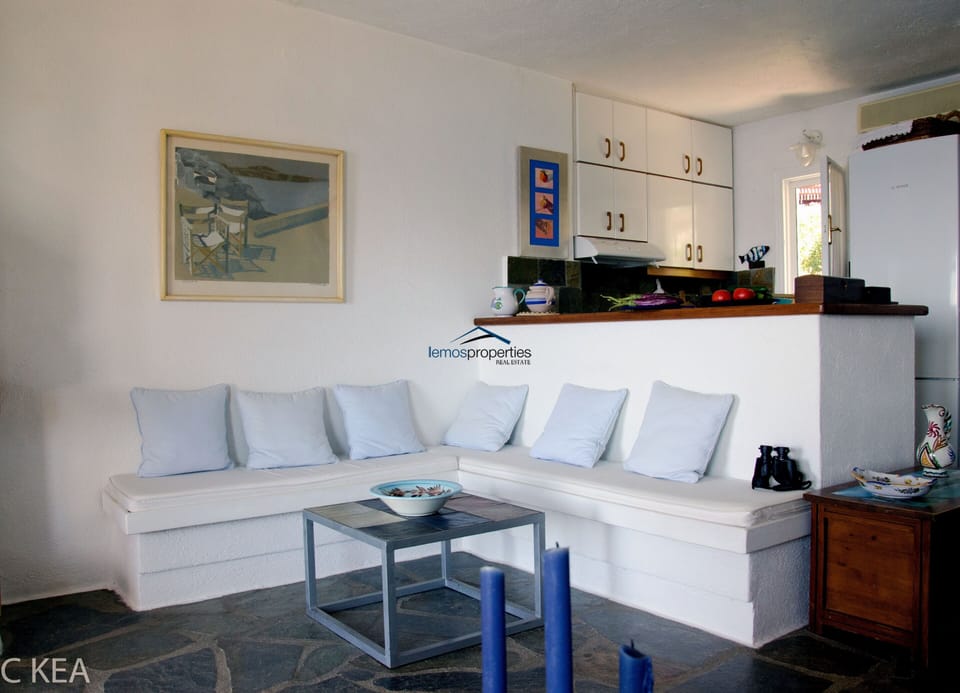 The living room with the open-plan kitchen