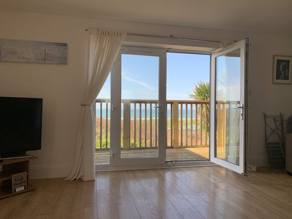 Open plan lounge kitchen diner leading onto balcony with great views