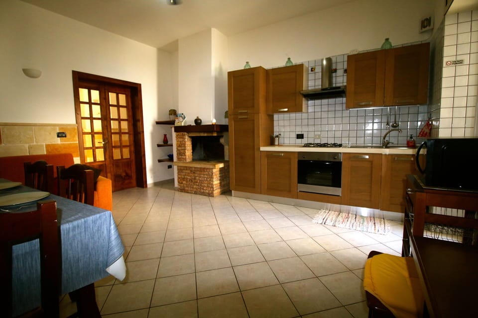 Spacious kitchen with dining table and comfortable sofa 