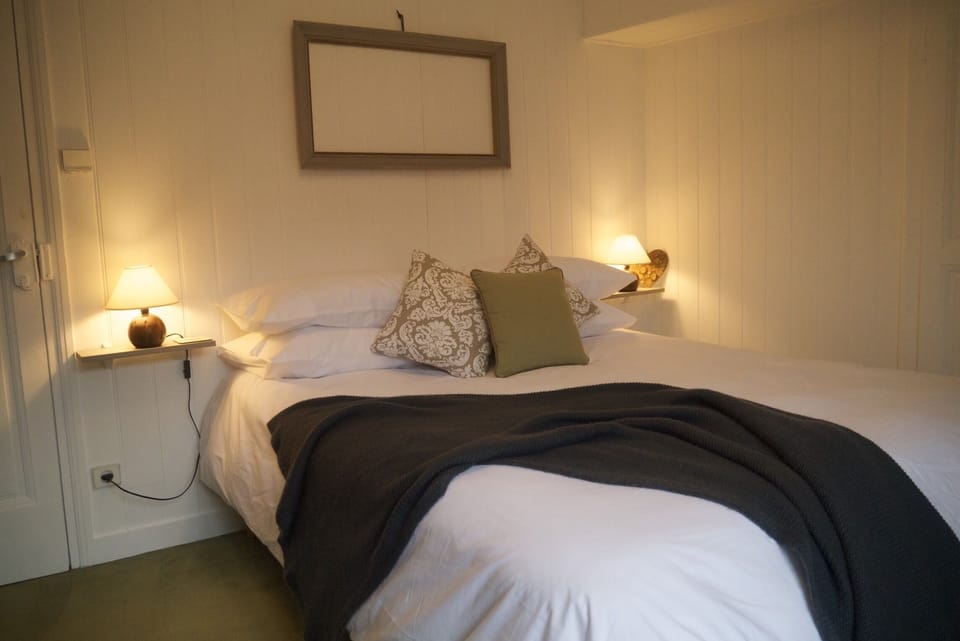 A beautiful master bedroom with lake glimpses across the rooftops