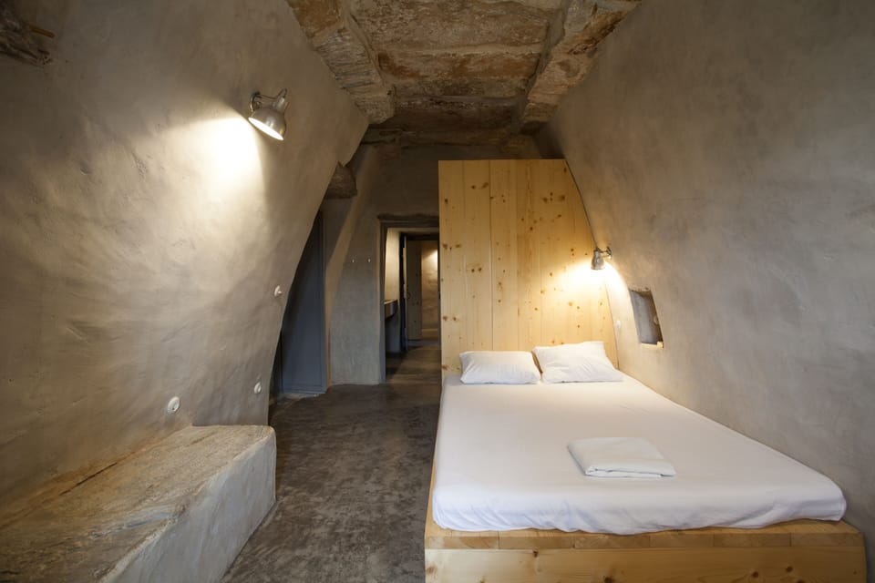 Main double bedroom, converging walls and stone slabs on top