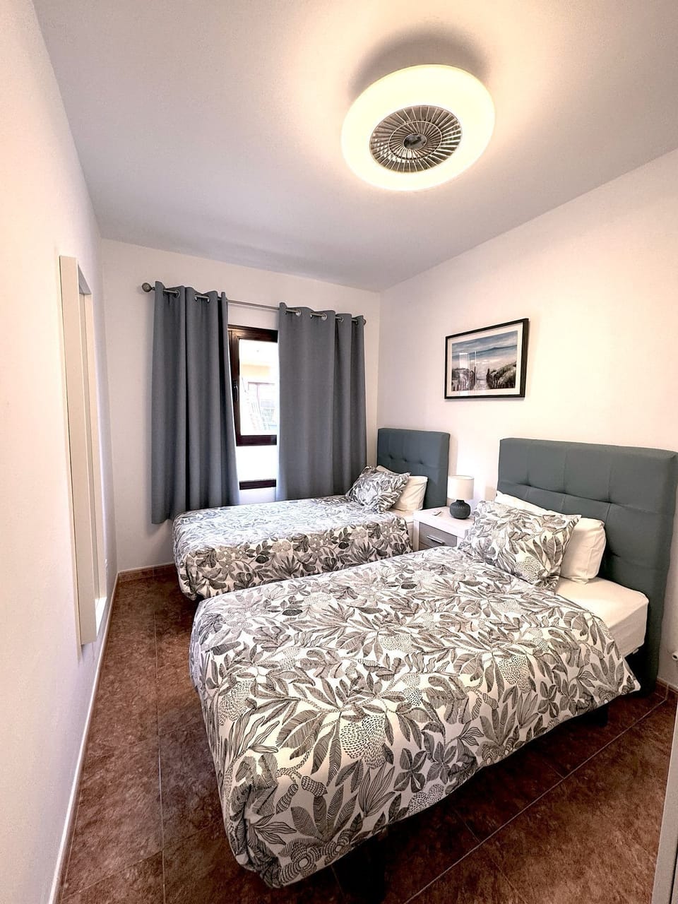 Back bedromm with 2 single beds and fitted wardrobes . Ceiling fans fitted 