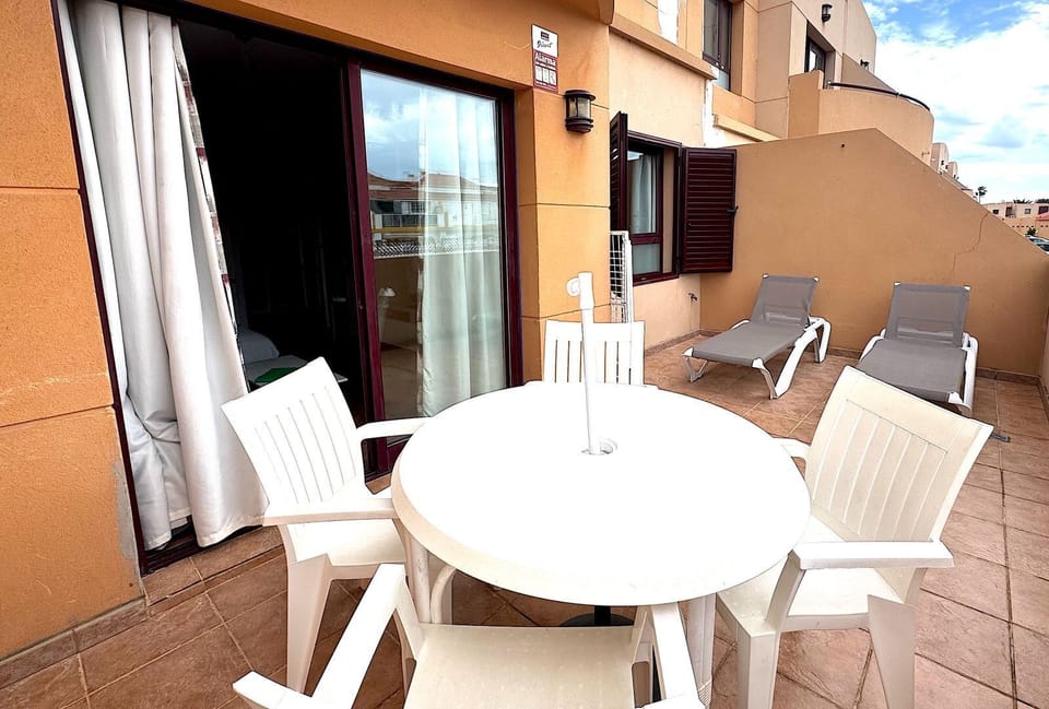 South facing patio area with sunbeds , table & chairs with umbrella 