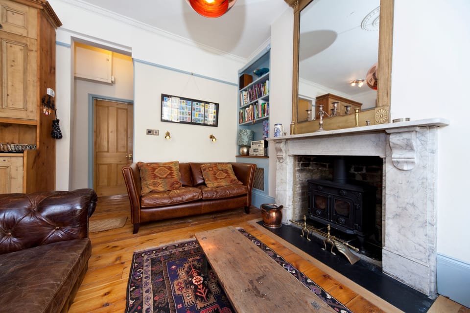 living area with plenty of sofa space and original fireplace