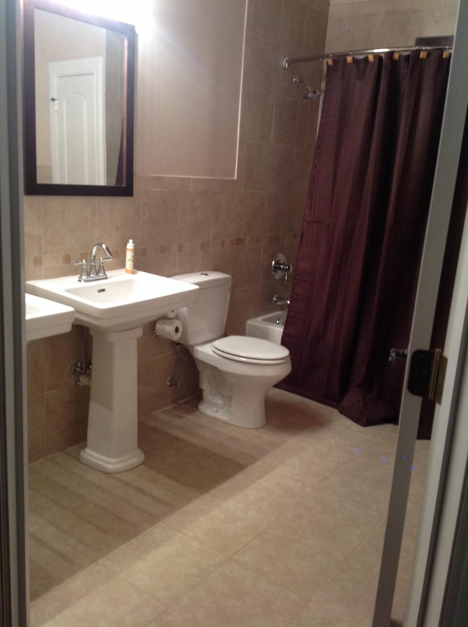 Spacious hall bath with double sinks and tub / shower