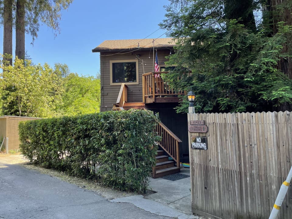 Front of house, surrounded by Redwood Trees.