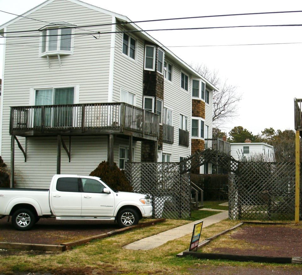 outside condo, with private parking area