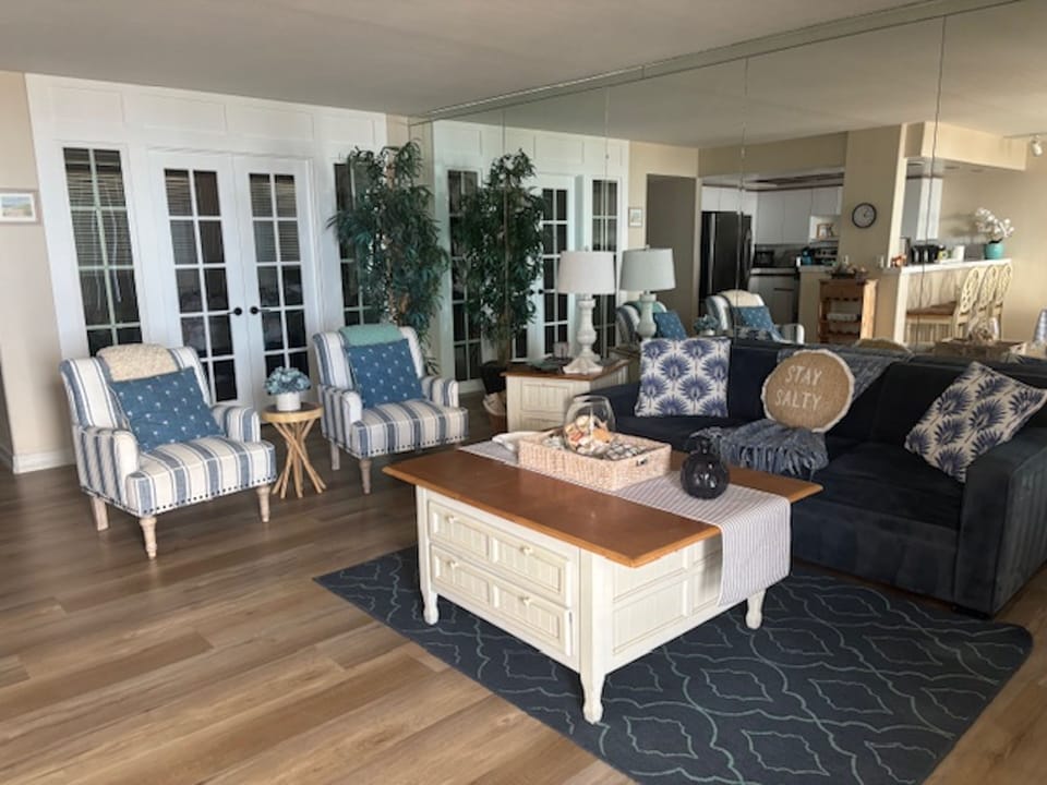 Large living room with beautiful french doors.  Amazing ocean & white water view