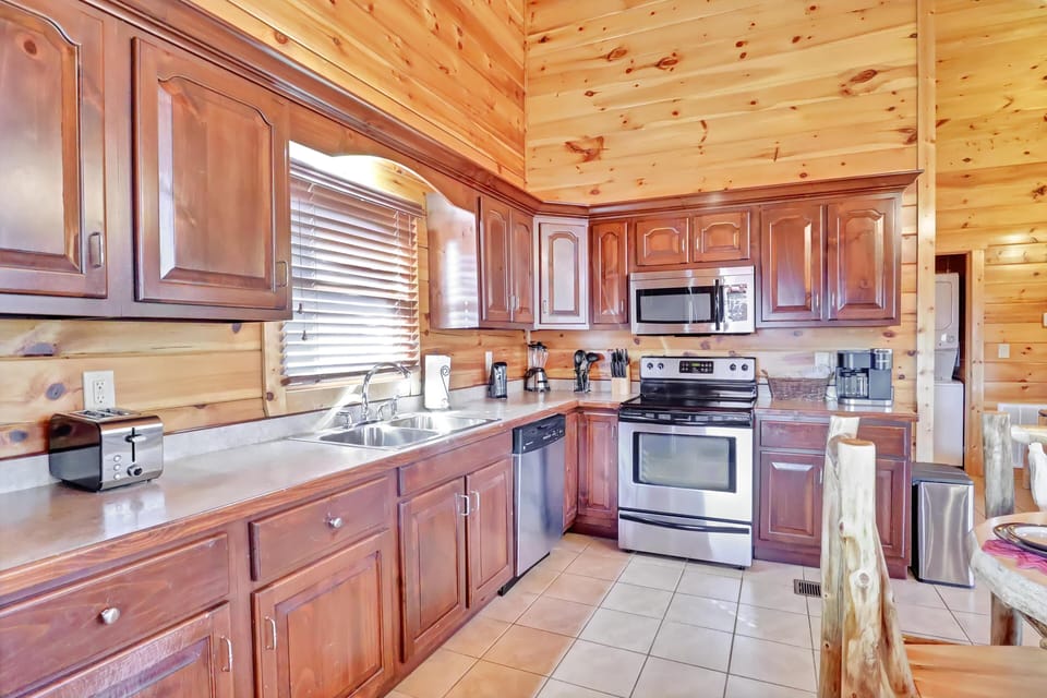 Full kitchen with pots &amp; pans, plates, glasses (including wine glasses), and utensils.