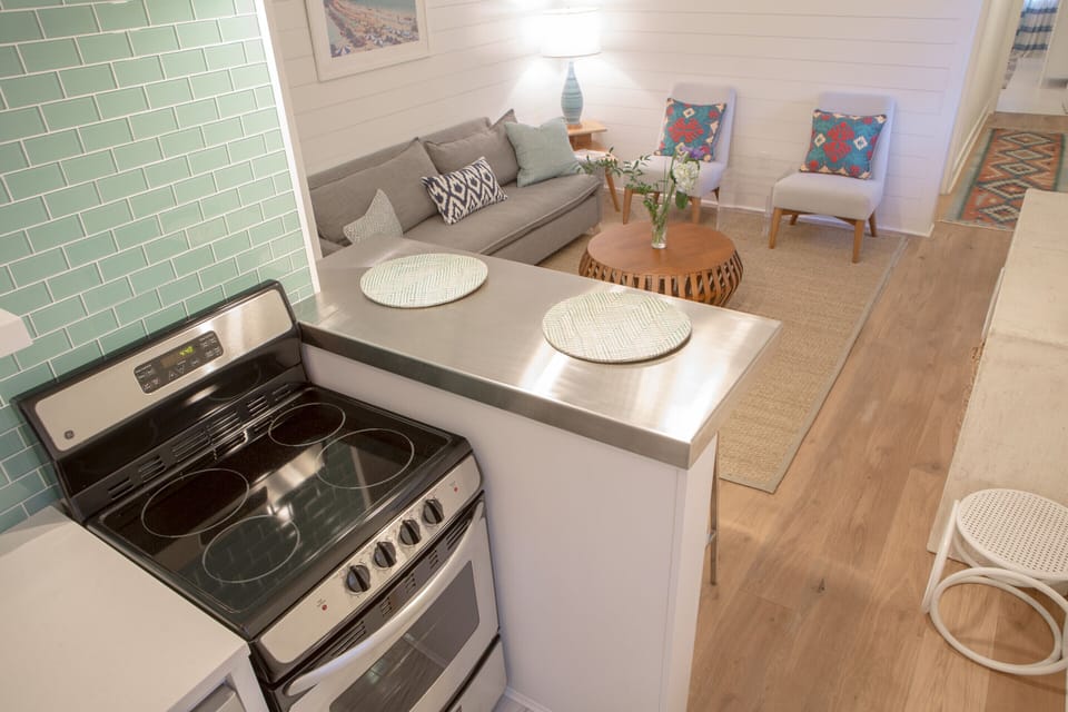 View from the downstairs kitchen into the den.  Nice 2-top stainless steel bar.