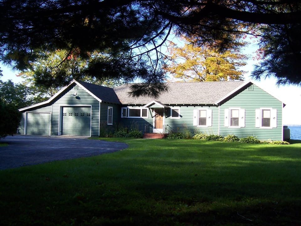 Street view of house showing proximity to lake and western view to North Hero.