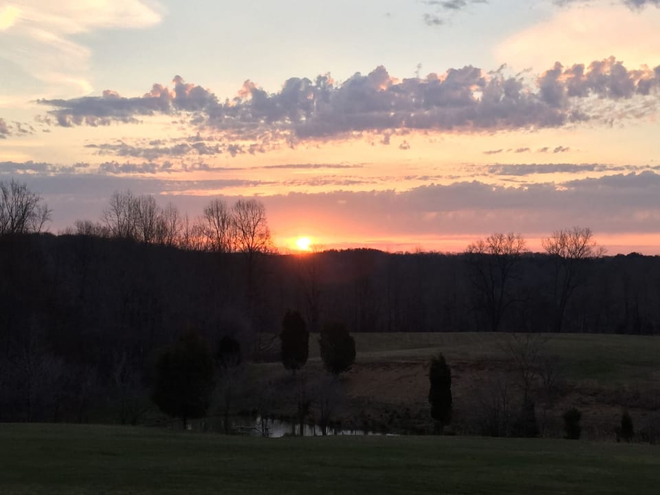 Watch the sun rise from the porch swing, rocking chairs or table