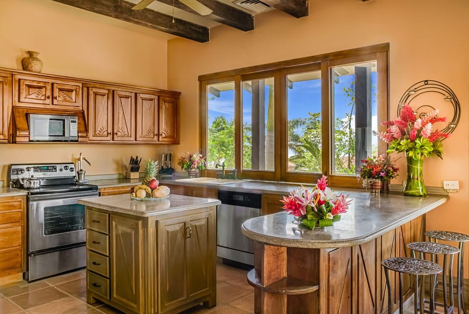CASA ANTIGUA ISLAND KITCHEN BREAKFAST BAR SLIDING WINDOWS TO THE DECK