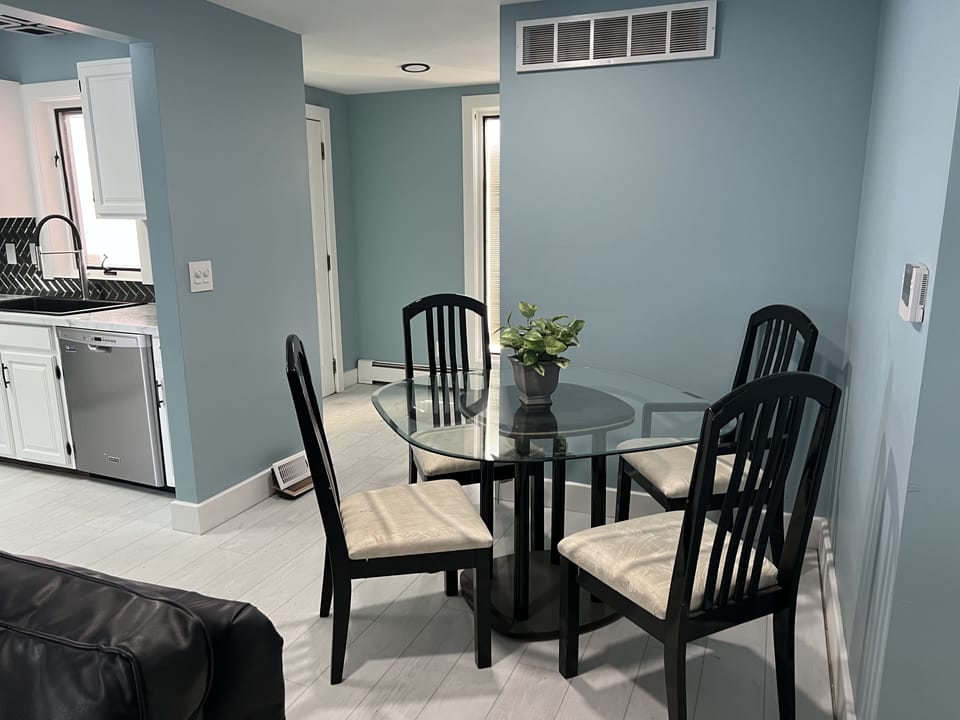 Dining table for four, two additional chairs are in the Condo.