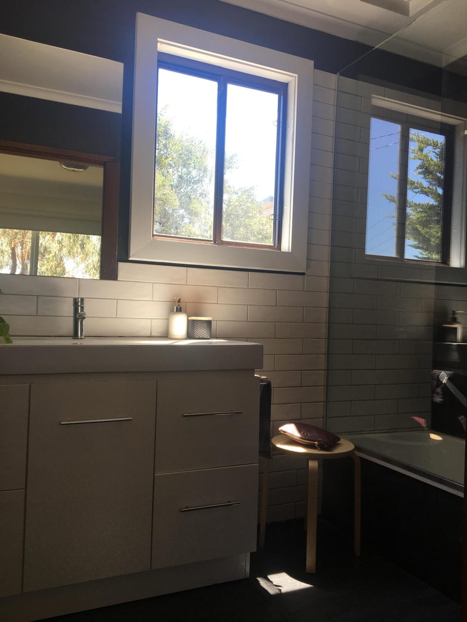 Downstairs full bathroom with bath and above bath shower