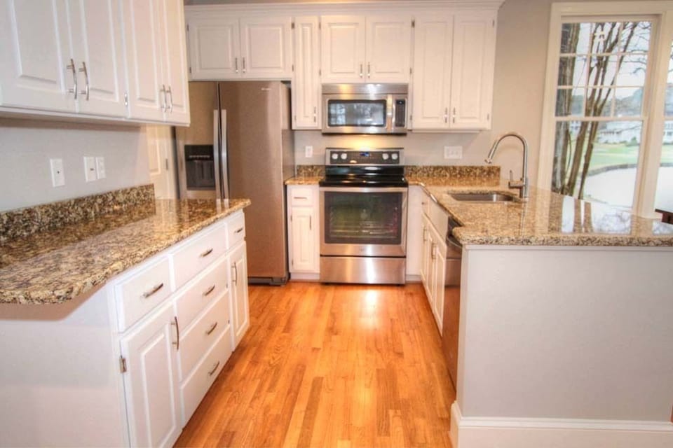 New Open Kitchen With Granite Countertops and Stainless Steel Appliances