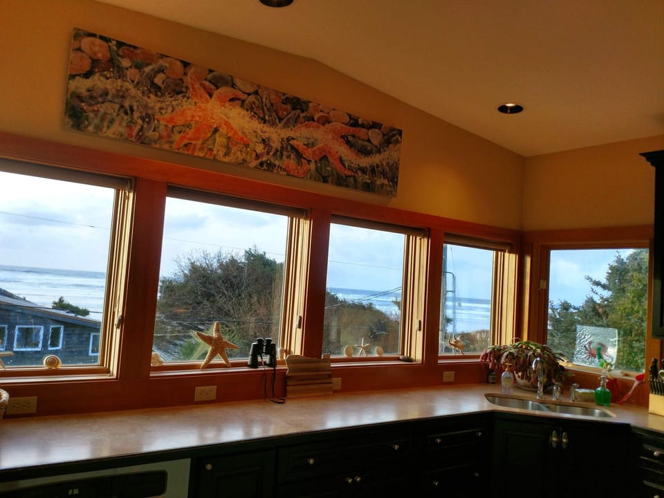 Wall to wall kitchen windows provide panoramic ocean views. Sunset views!