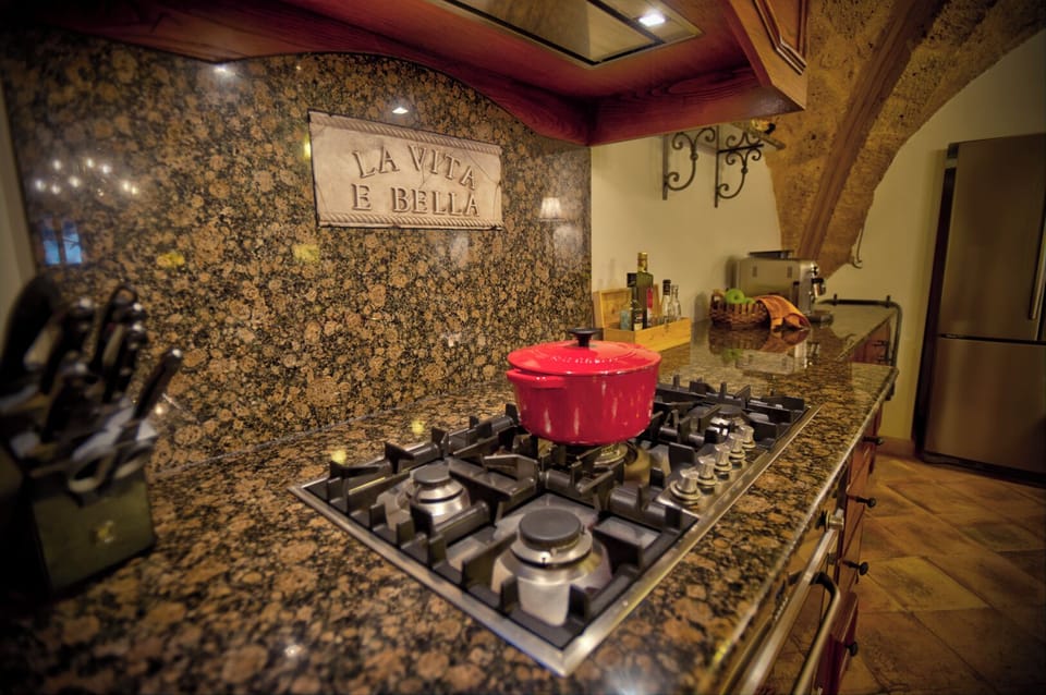 Large kitchen counter with lots of cooking equipment.
