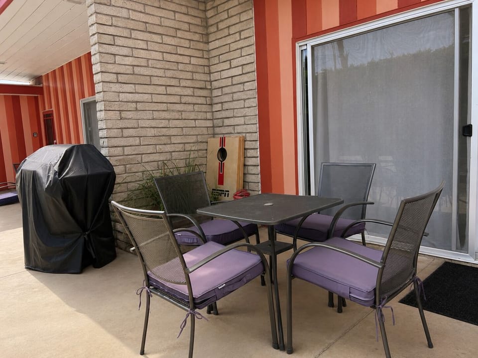 Enjoy your own private table and chairs, plus a cornhole set for some outdoor entertainment.