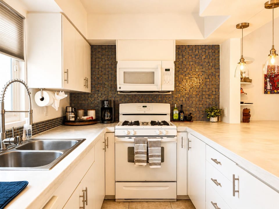 Prepare home-cooked meals with ease in a fully stocked kitchen featuring modern appliances and all the essentials.