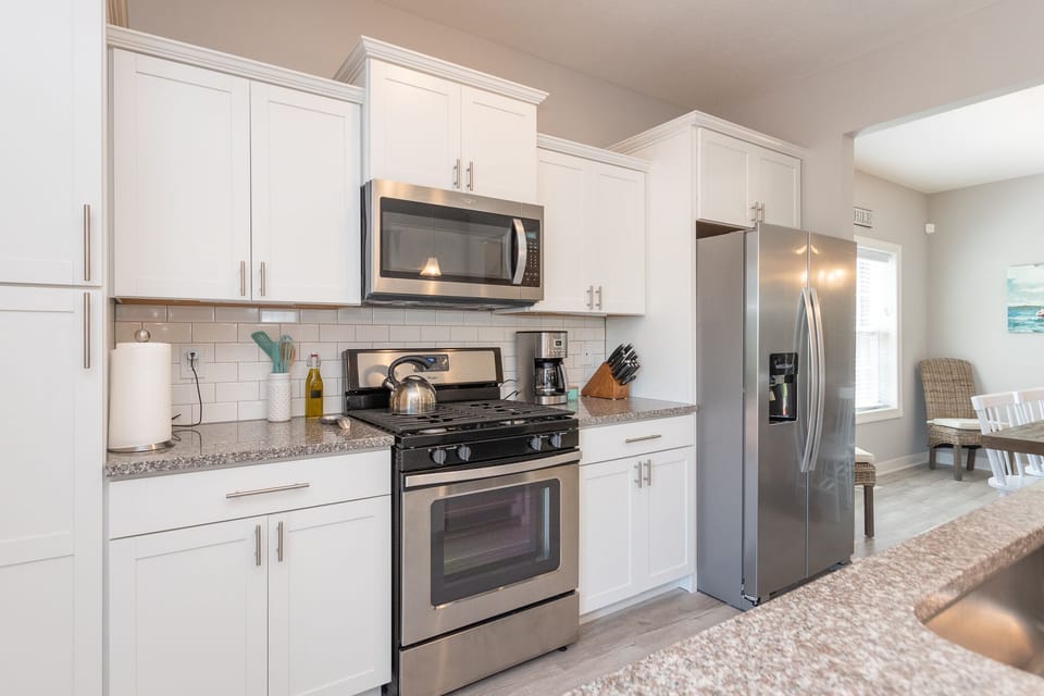 Stainless steel appliances.  Gas range, fridge with water and ice maker.  