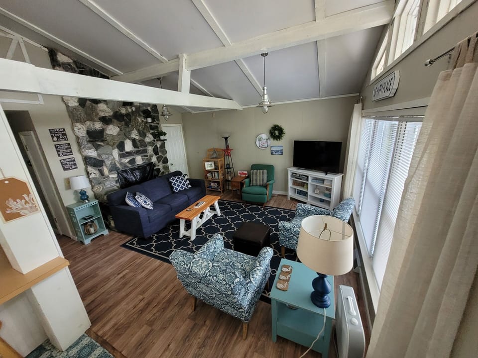 Living room with 50 inch smart TV and views of the lake.