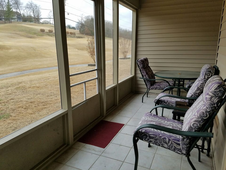 walk out screen back patio with a babbling brook and golf fairway view 