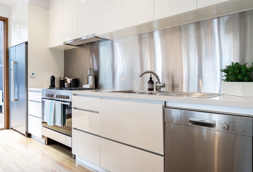The kitchen has a fridge, dishwasher, 900mm oven, 5 gas cooktop and microwave
