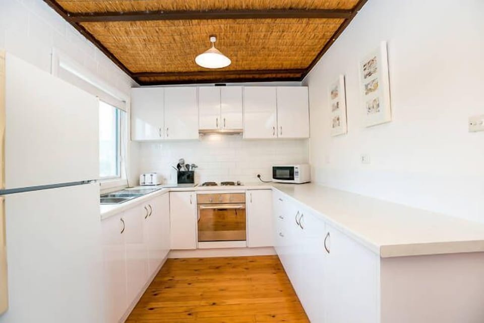 Kitchen, stovetop, microwave,  refrigerator, oven, coffee machine.
