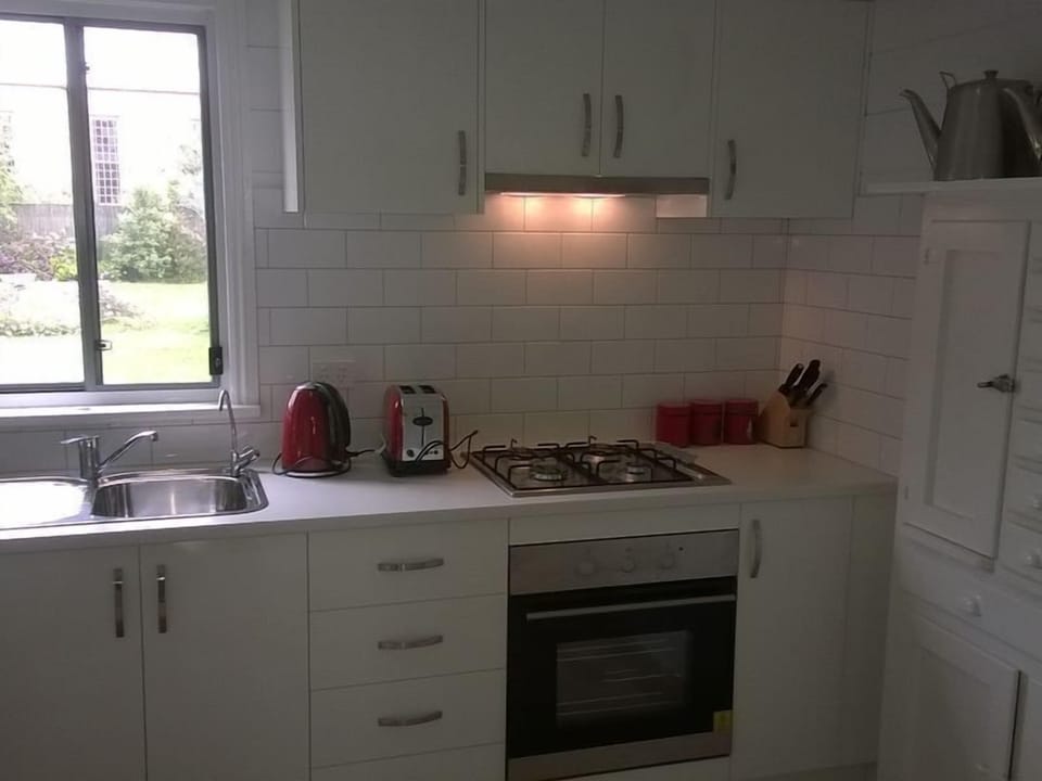 A corner of the kitchen with gas stove and oven.