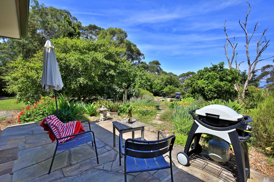 private patio overlooking orchard with views to the sea